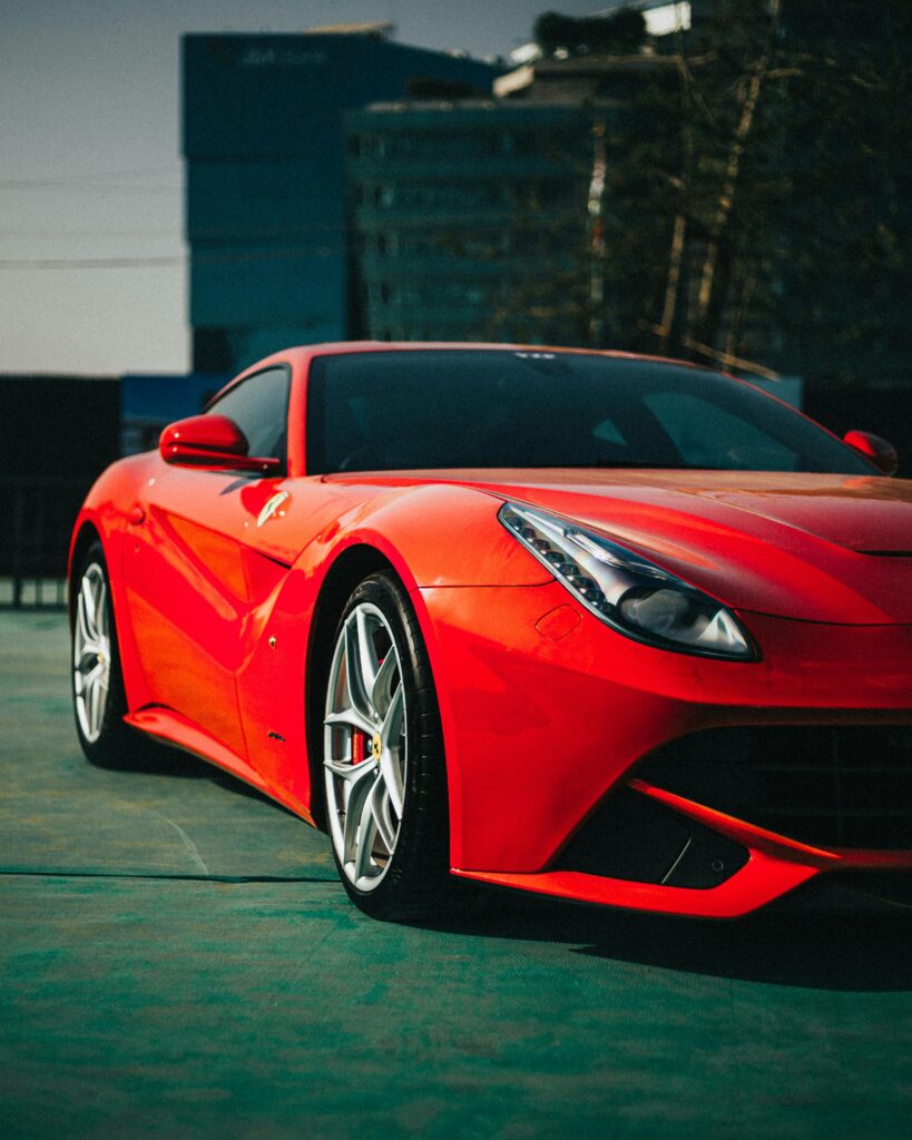 Stylish red sports car parked outdoors in Mumbai, showcasing luxury and performance.